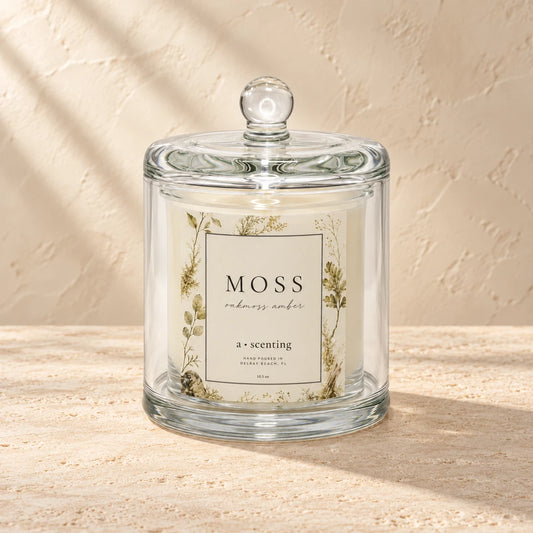 Moss candle styled on a warm ivory background