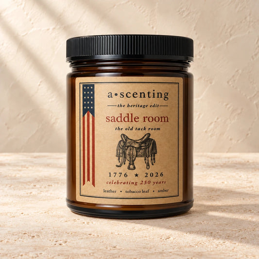 Saddle Room | Leather, Tobacco leaf & Amber candle styled on a warm ivory background