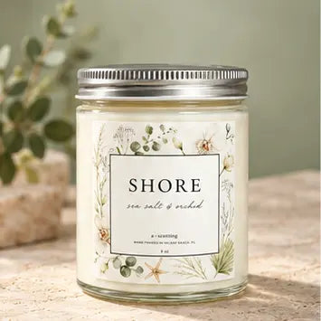 Classic nine ounce candle jar with a silver lid against soft sage