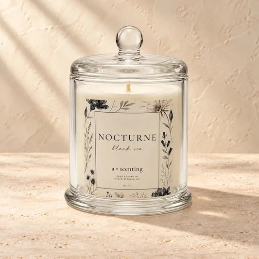 Nocturne Conservatory soy candle in a glass cloche with its original botanical label