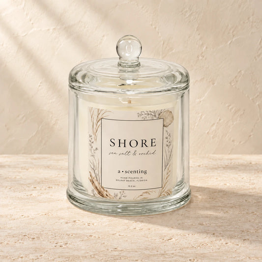Shore candle styled on a warm ivory background