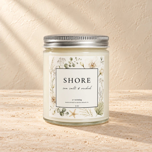 Shore | Sea salt & orchid candle styled on a warm ivory background