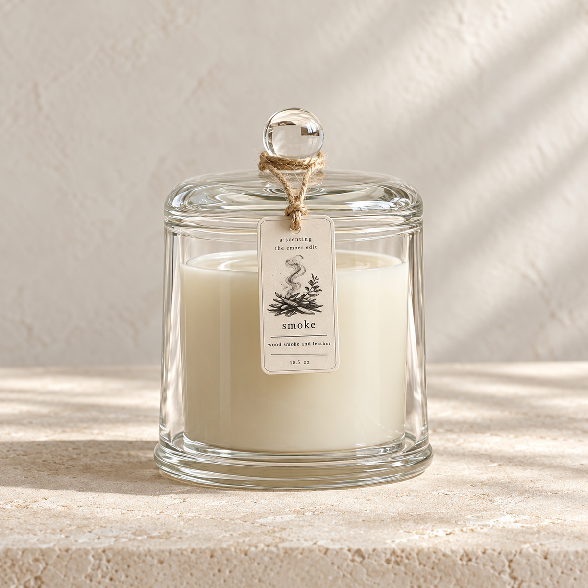 Smoke wood smoke and leather 10.5 oz soy candle in a clear glass dome with a Smoke hang tag